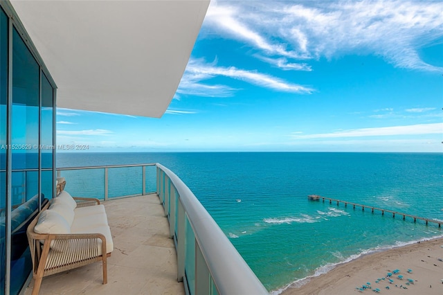 balcony with a view of the beach and a water view