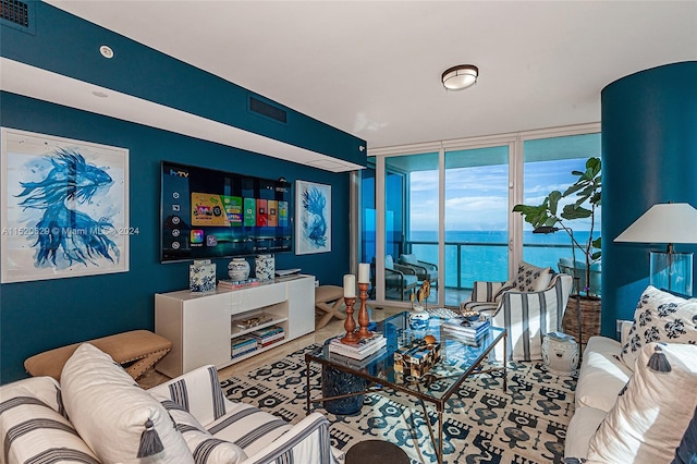 living room with a water view and a wall of windows