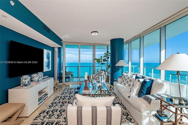 living room featuring a water view and expansive windows