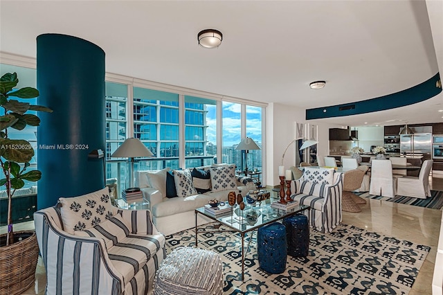 living room with light tile floors and floor to ceiling windows