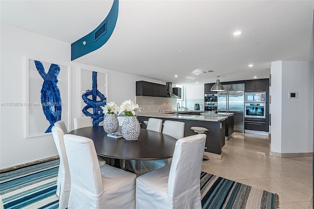 tiled dining space featuring sink