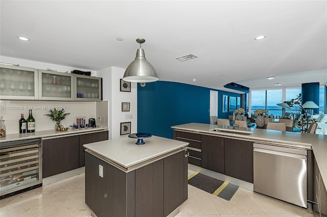 kitchen with sink, wine cooler, dishwasher, a kitchen island, and dark brown cabinetry