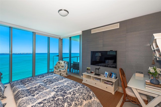 bedroom featuring a water view and access to outside