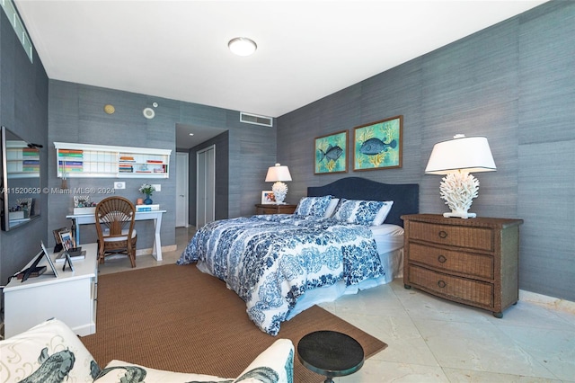 bedroom with tile walls and light tile floors