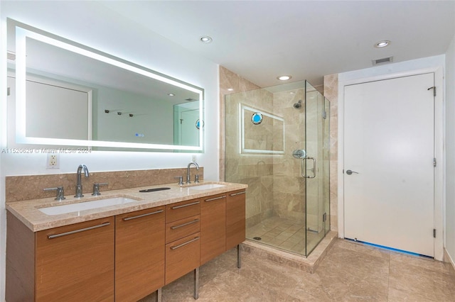 bathroom featuring an enclosed shower, tile flooring, and double vanity