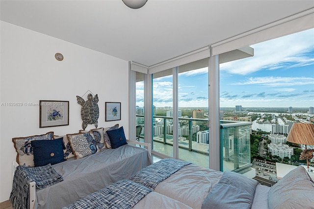 bedroom featuring access to exterior and a wall of windows