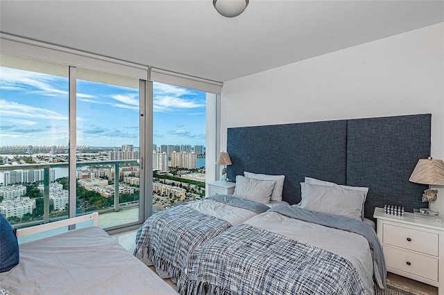 bedroom featuring expansive windows and access to exterior