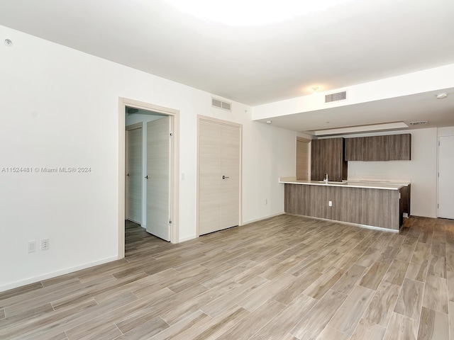 spare room with light hardwood / wood-style flooring and sink