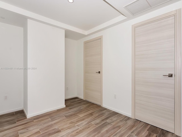 spare room with light hardwood / wood-style flooring