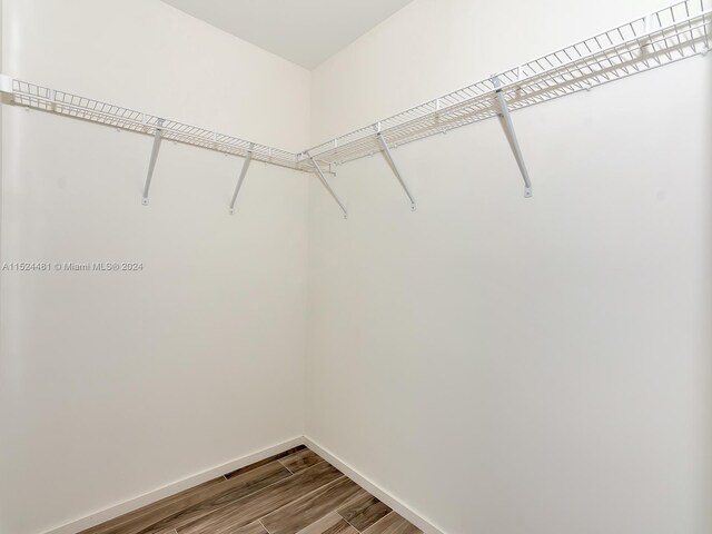 walk in closet featuring hardwood / wood-style floors