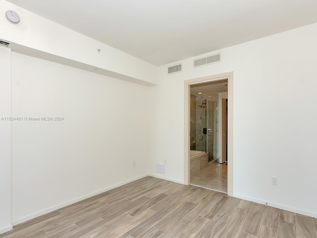 spare room with light hardwood / wood-style floors