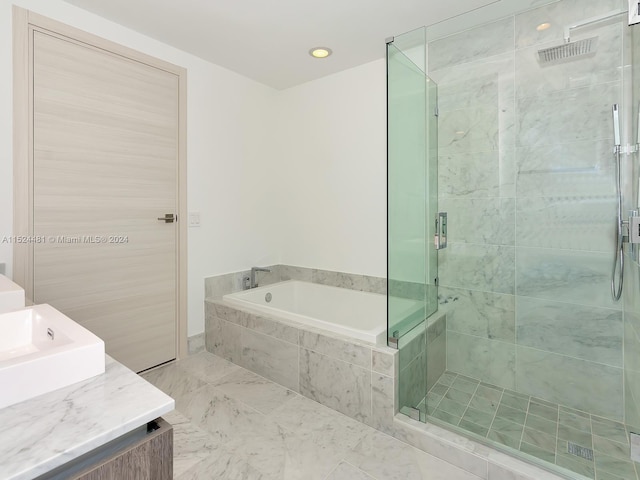 bathroom featuring shower with separate bathtub, tile walls, tile floors, and vanity