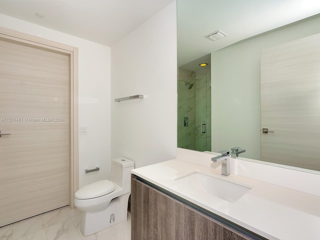 bathroom with toilet, vanity with extensive cabinet space, tile flooring, and tiled shower