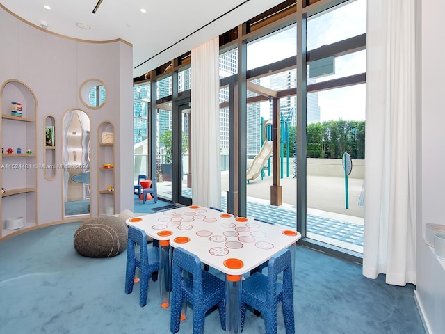 carpeted dining room featuring expansive windows