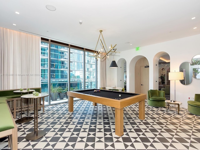 game room featuring light tile floors, pool table, and a wall of windows