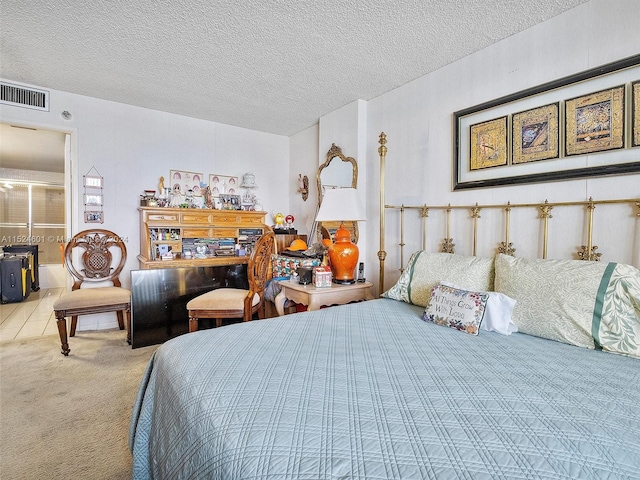 bedroom featuring a textured ceiling and light colored carpet