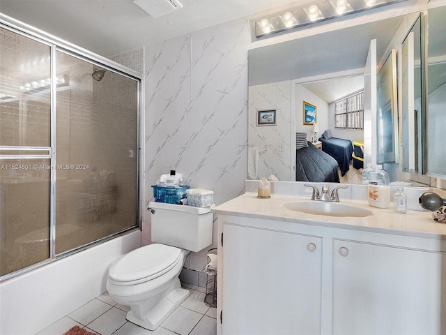 full bathroom featuring vanity, combined bath / shower with glass door, tile flooring, and toilet