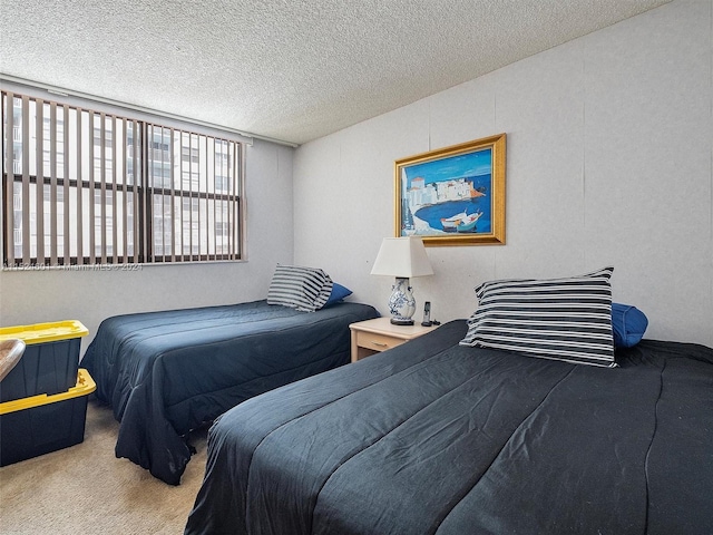 bedroom with a textured ceiling and carpet floors