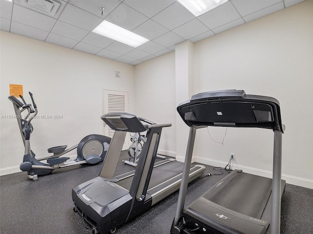 exercise room with a paneled ceiling