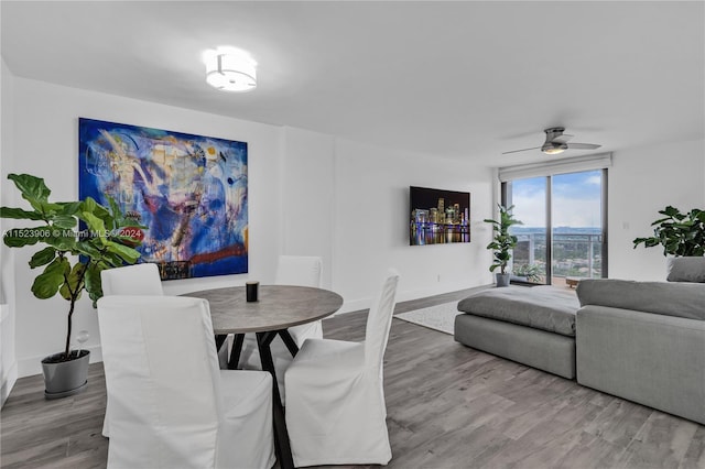 dining area featuring hardwood / wood-style flooring and ceiling fan