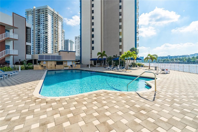 community pool featuring a city view and a patio area