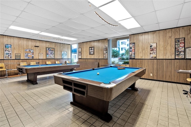 rec room with tile patterned floors, wood walls, and billiards