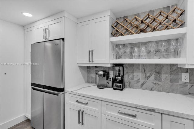 kitchen featuring white cabinetry, open shelves, and freestanding refrigerator