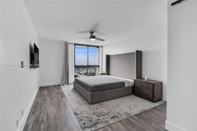 bedroom featuring hardwood / wood-style floors and ceiling fan