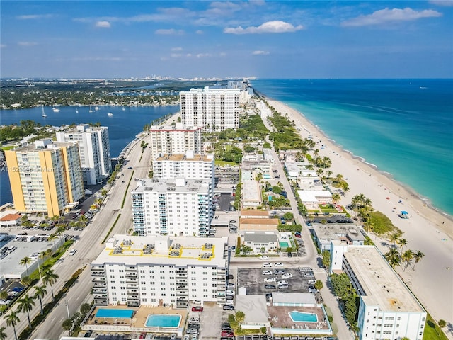 birds eye view of property with a water view, a city view, and a view of the beach