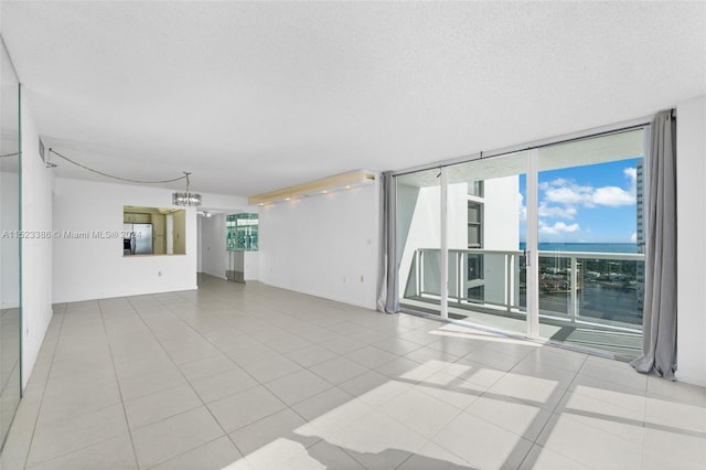 unfurnished living room with light tile patterned floors and a textured ceiling