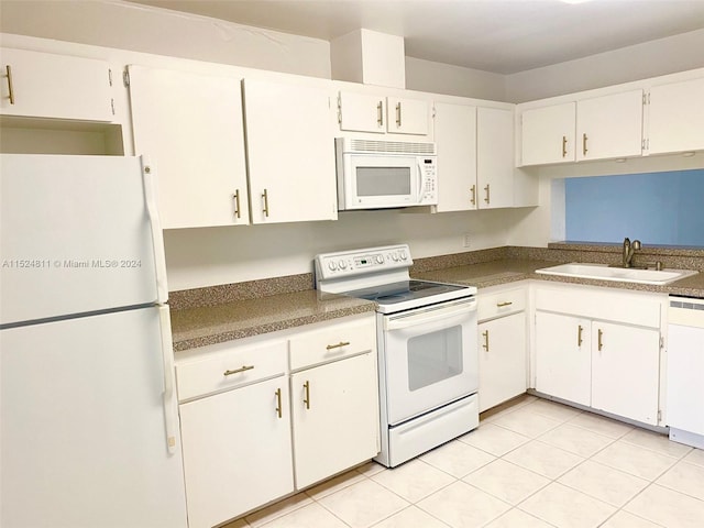 kitchen with light tile floors, white appliances, white cabinetry, and sink