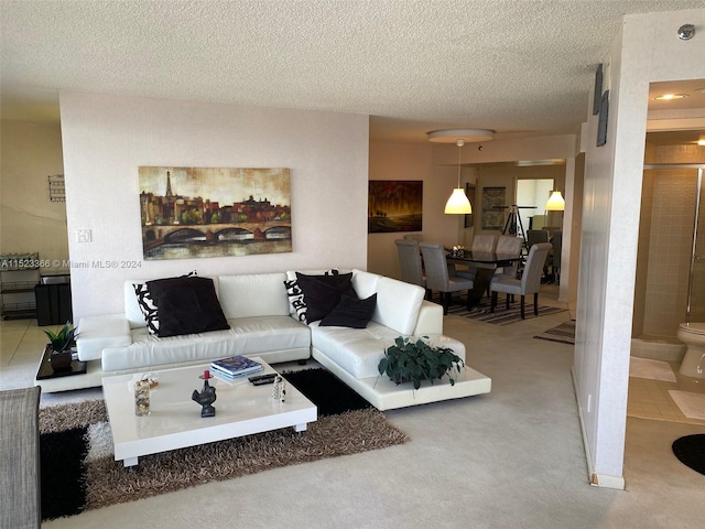 carpeted living room featuring a textured ceiling