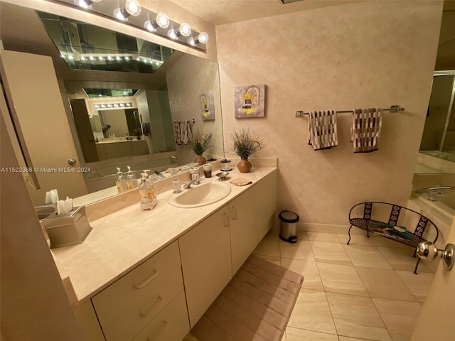 bathroom featuring vanity with extensive cabinet space and tile flooring