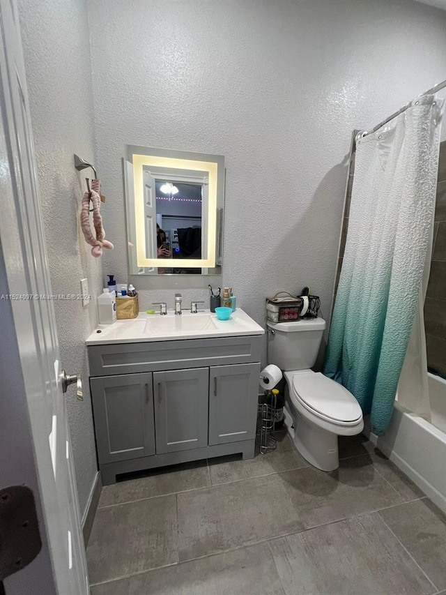 full bathroom featuring vanity, tile flooring, shower / bath combo with shower curtain, and toilet