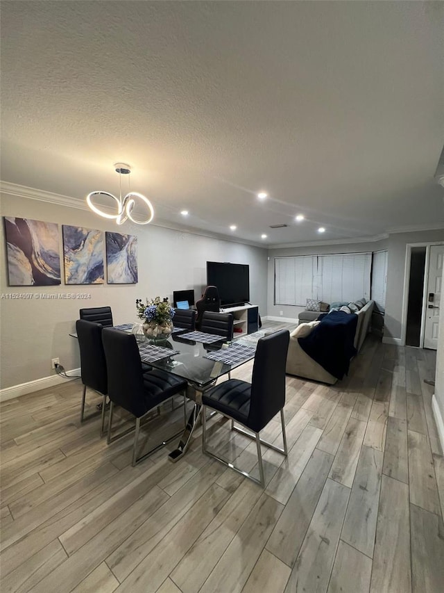 dining room featuring light hardwood / wood-style floors, a textured ceiling, and a chandelier