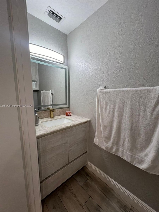 bathroom with vanity and hardwood / wood-style floors