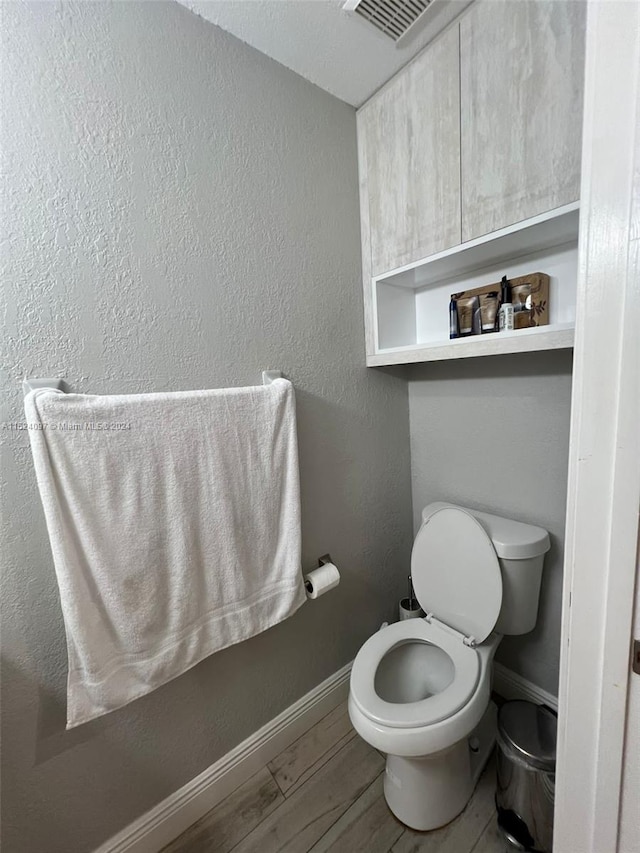 bathroom featuring toilet and hardwood / wood-style flooring