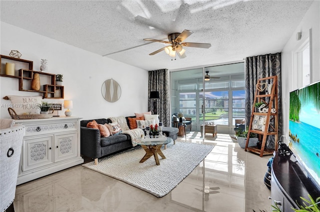 tiled living room with a textured ceiling and ceiling fan