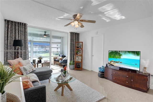 living room with floor to ceiling windows, a textured ceiling, ceiling fan, and light tile floors