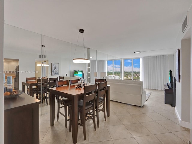 dining area featuring light tile patterned floors and visible vents