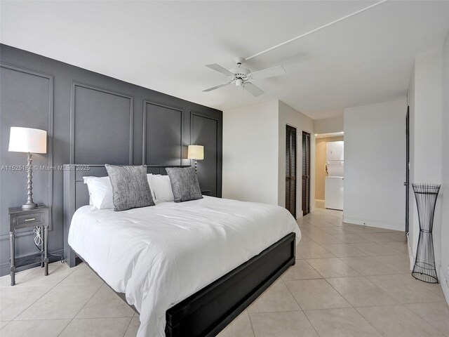 bedroom with access to exterior, light tile patterned floors, a closet, and ceiling fan