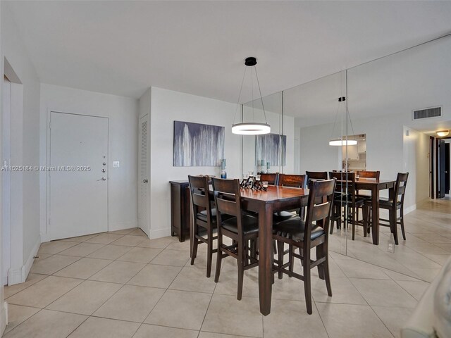 dining space featuring light tile patterned floors