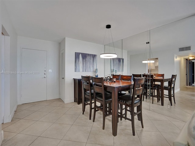 dining room with light tile patterned floors, visible vents, and baseboards