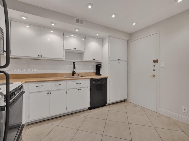 kitchen with white cabinets, a sink, black appliances, and light tile patterned floors