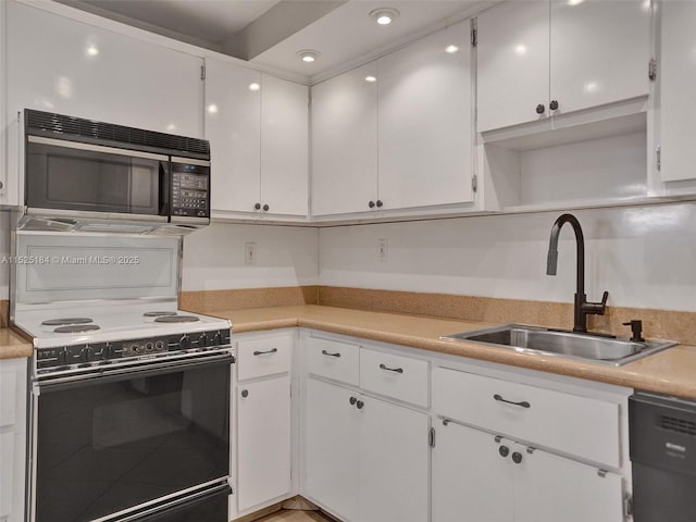 kitchen with light countertops, white cabinets, a sink, and black appliances