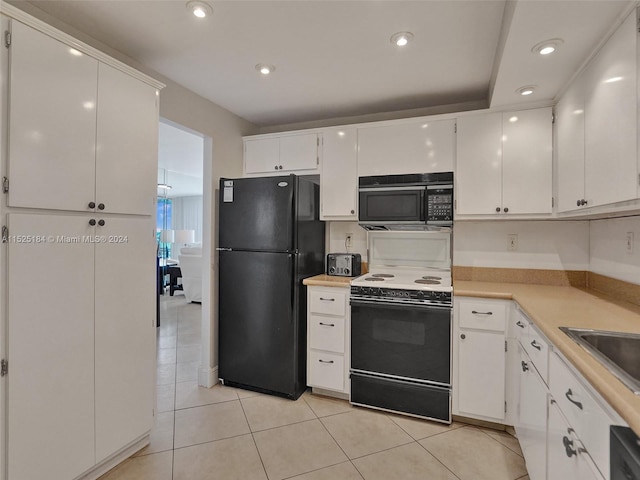 kitchen featuring white cabinets, light tile patterned floors, and black appliances