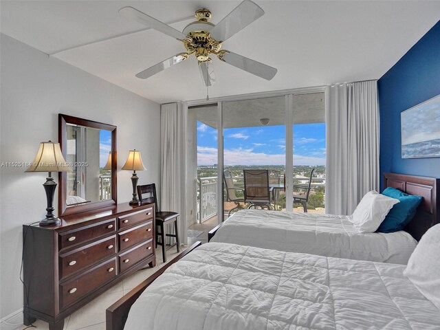 tiled bedroom featuring access to exterior, ceiling fan, and expansive windows