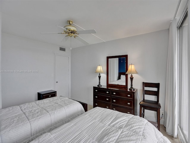 bedroom featuring baseboards, visible vents, and a ceiling fan