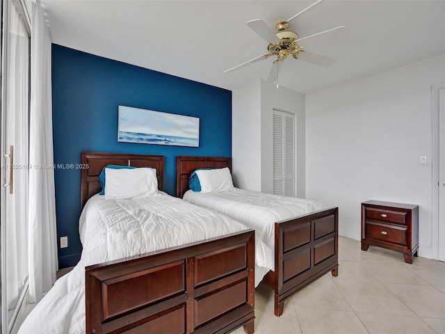 bedroom with ceiling fan and light tile patterned flooring