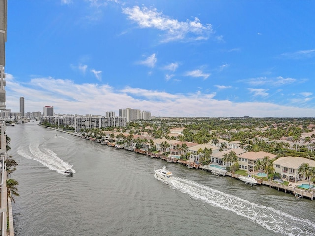 birds eye view of property featuring a water view and a view of city